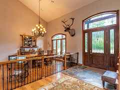 Vaulted entry and view into formal dining area